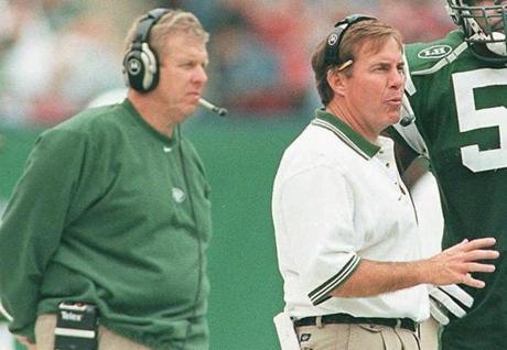 FILE--New York Jets defensive coordinator Bill Belichick, center, talks with Jets linebacker Bryan Cox (51) on the sideline as head coach Bill Parcells stands in the background during a game against the Indianapolis Colts at Giants Stadium in East Rutherford, N.J. Oct. 17, 1999. Belichick quit Tuesday, Jan. 4, 2000 as head coach of the New York Jets, one day after being elevated to the job when Parcells resigned. (AP Photo/John T. Greilick) <%% 0 PICTURE_OK HEADER_OK 2 1 %%> library tag 01052000 Sports
